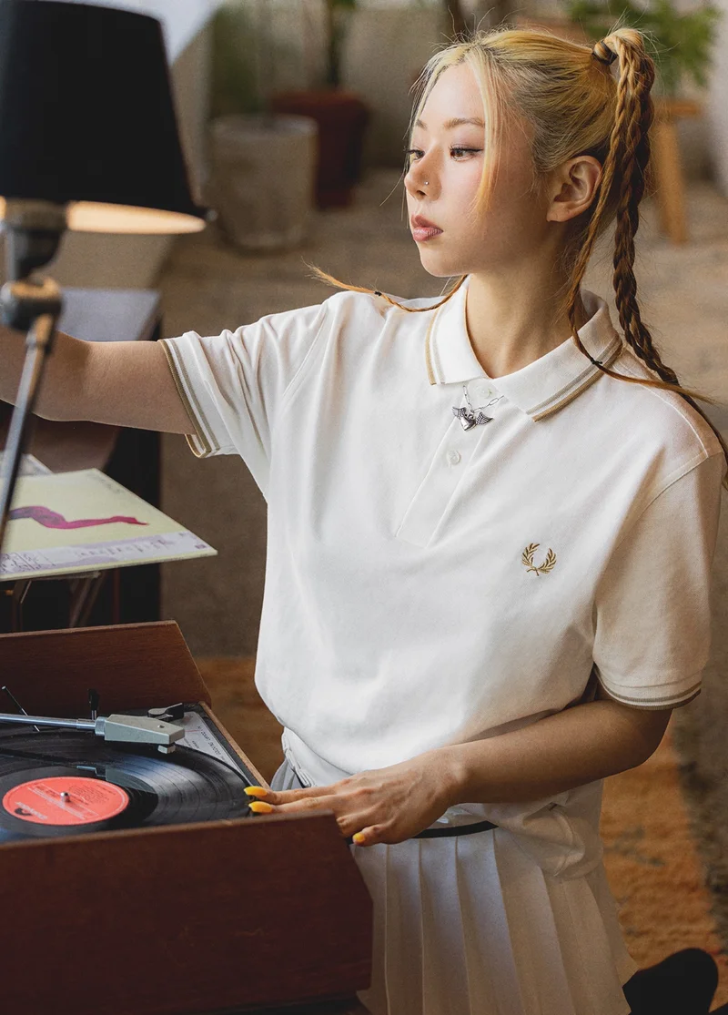 Asian female model wearing a fred perry shirt