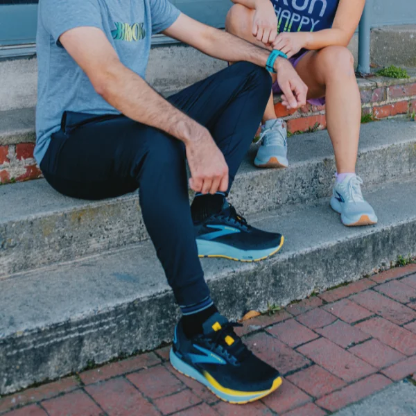 Man and woman wearing Brooks Ghost shoes