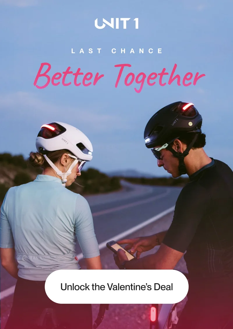 A couple wearing FARO and AURA helmets, enjoying a shared cycling moment at sunset.