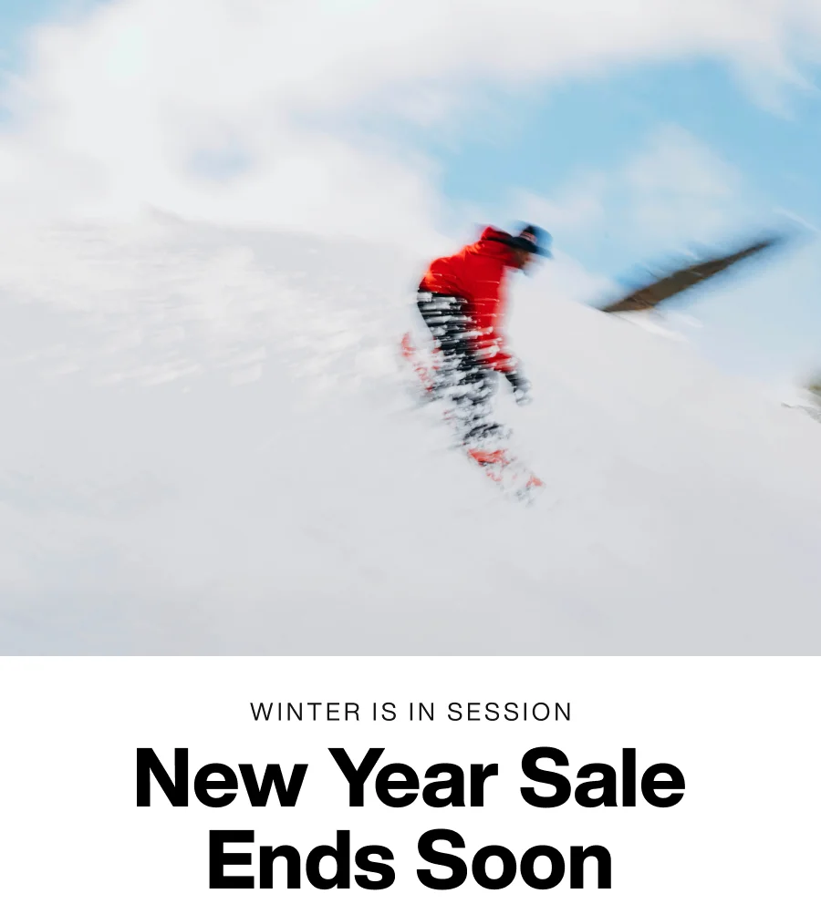 Blurry shot of a snowboarder with the text 'Winter is in session- New Year Sale ends soon.'