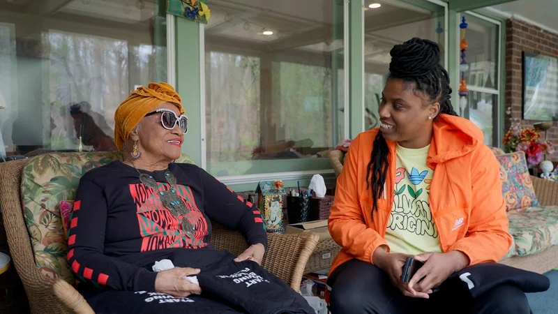 Two women sitting and smiling