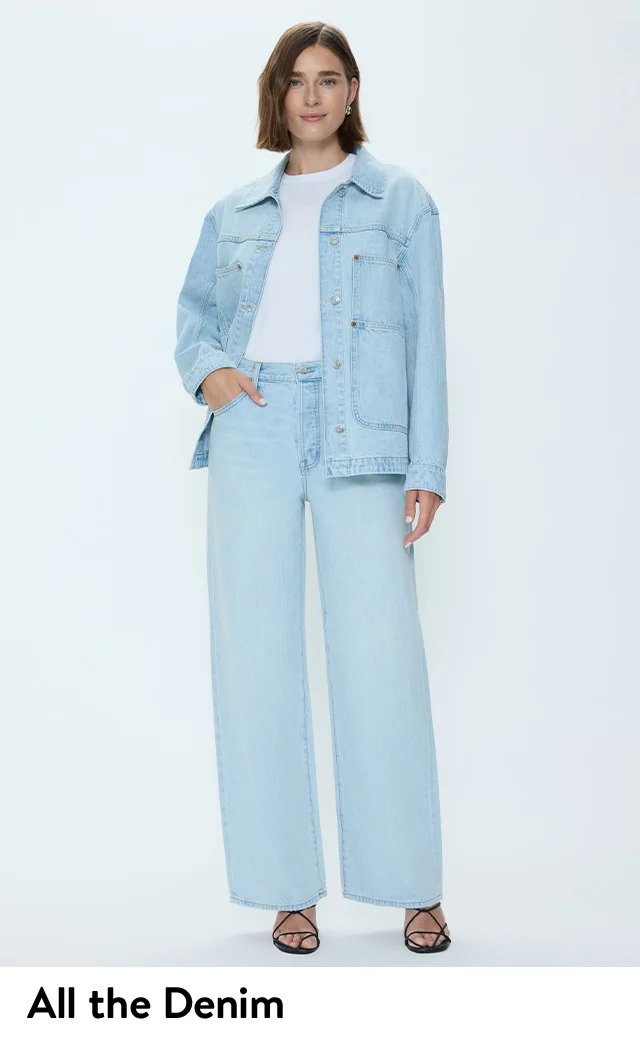 A woman wearing a denim jacket and matching pants.