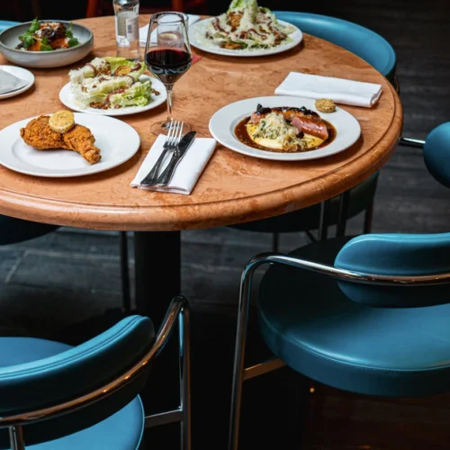 A stylish table with a full meal paired with wine