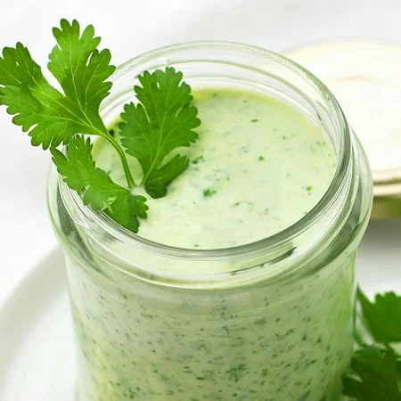 Creamy herb dressing in a jar, highlighted as a nourish by nutribullet recipe for drizzling or dipping.