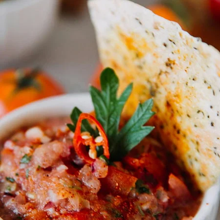 Fresh pantry salsa topped with herbs, shown as an easy nourish by nutribullet recipe.