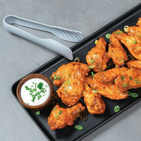 Crispy air fryer chicken wings served with a creamy dip, featured as a nourish by nutribullet recipe.