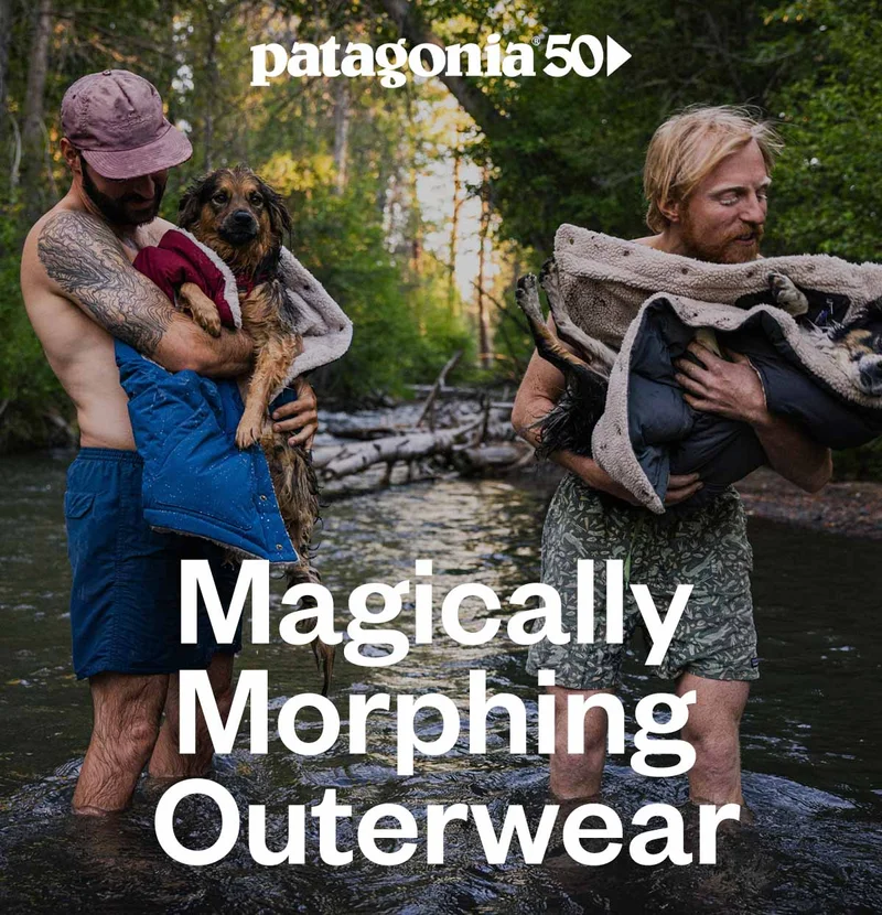 Patagonia 50. Magically morphing outerwear. Two people standing in a river holding their dogs wrapped in warm vests.