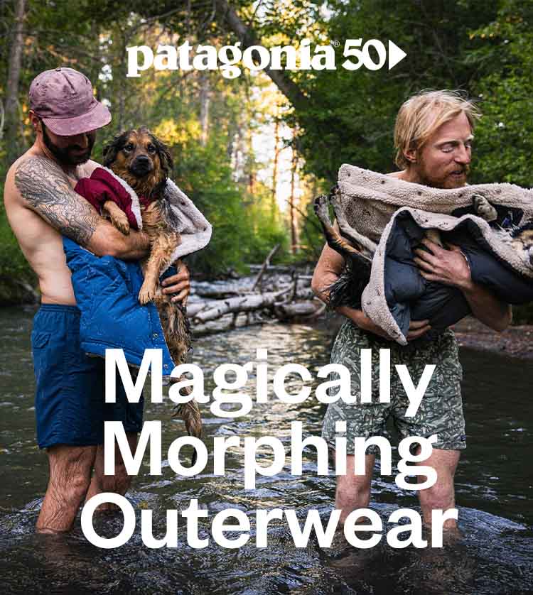 Patagonia 50. Magically morphing outerwear. Two people standing in a river holding their dogs wrapped in warm vests.