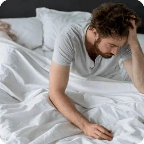 man waking up from a bad sleep while wife sleeps beside him man waking up from a bad sleep while wife sleeps beside him