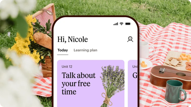 Phone showing Babbel's app in front of a picnic.