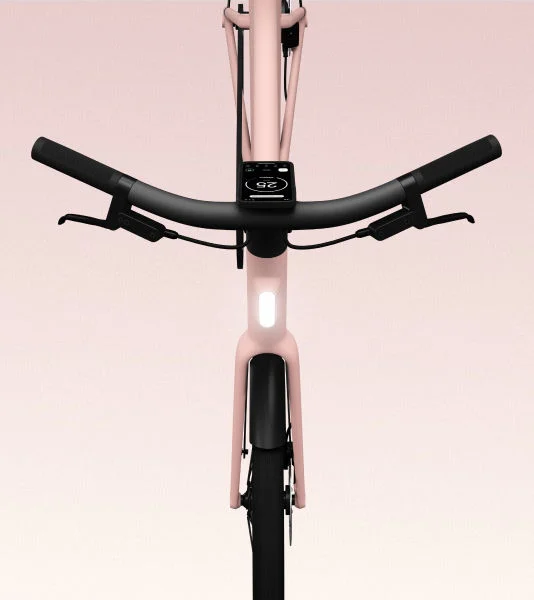 A front-facing view of the Cowboy bike in the Dawn colorway, highlighting the sleek handlebar design, integrated front light, and smart display.