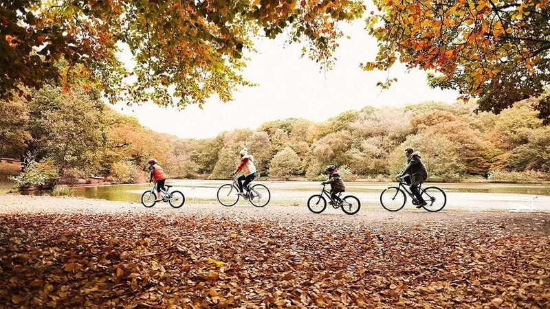 Image description: Family biking in London in the fall.