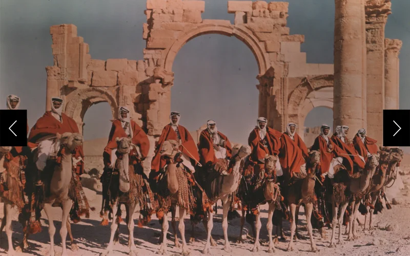 A Syrian desert patrol on camelback visits the ruins of Palmyra in a 1938 Dufaycolor.