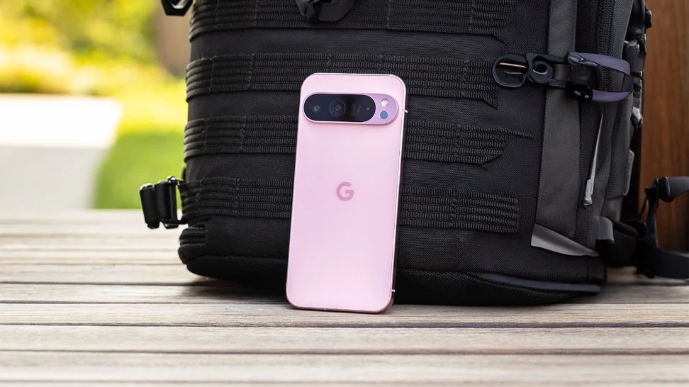 A photo of a Pixel 9 phone leaning against a backpack
