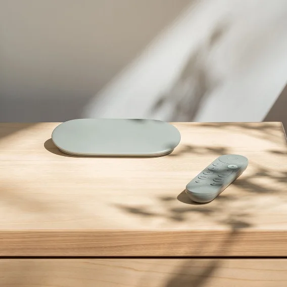 Image of a Google TV Streamer with remote on a table