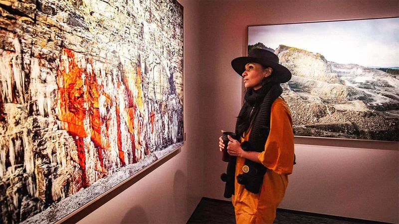 Image description: Woman viewing artwork at Fotografiska Museum.