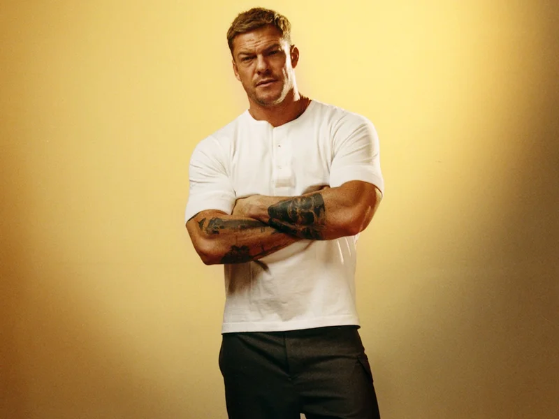 Image may contain: Alan Ritchson, Face, Head, Person, Photography, Portrait, Adult, Happy, and Smile