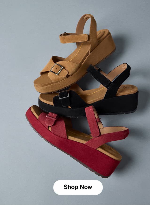 A fanned arrangement of the Baminda wedge sandal in Tan, Black, and Ruby suede. Shop Now.