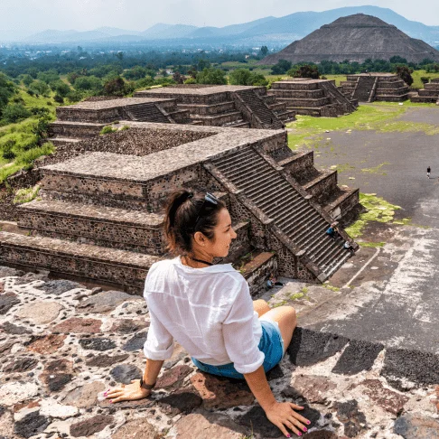 Image Description: A traveler looking at the ancient pyramids of Teotihuacán, a popular day trip destination from Mexico City