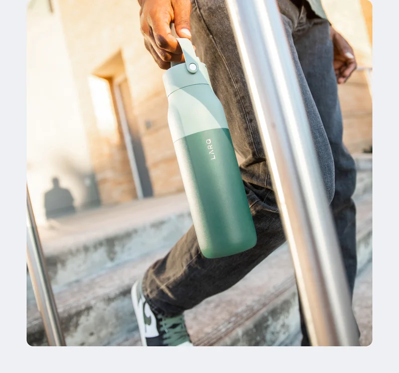 Man holding LARQ Bottle Swig Top in Eucalyptus Green