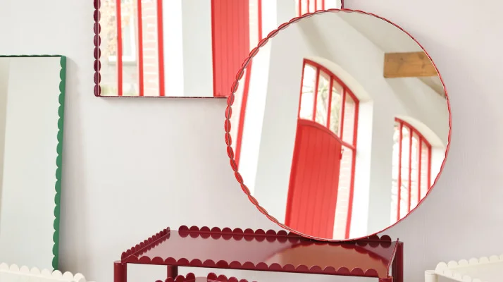 Two Arcs Mirrors in red, rectangular and round, above two Arc Trolleys in red.