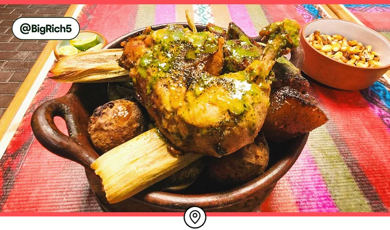 Image description: Chicken, humitas (corn cakes cooked in husks), potatoes, and more as part of a pachamanca feast.