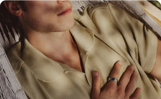 Person wearing Oura Ring lying in hammock
