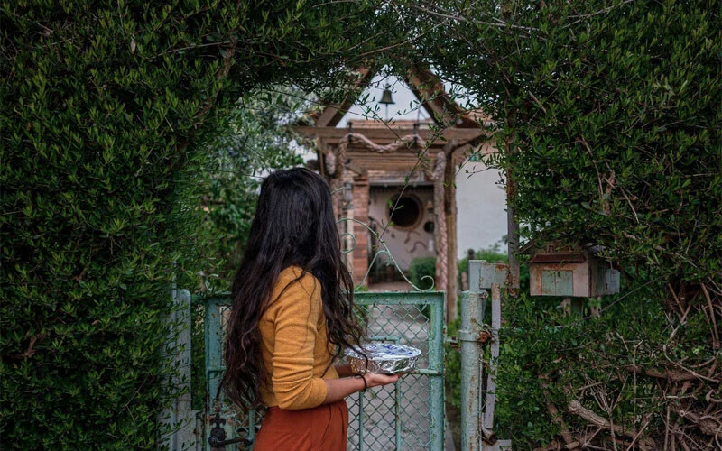 A woman brings a meal to her widowed neighbor. Research shows that acts of kindness like this strengthen social bonds and contribute to better mental and physical health for both the giver and receiver.