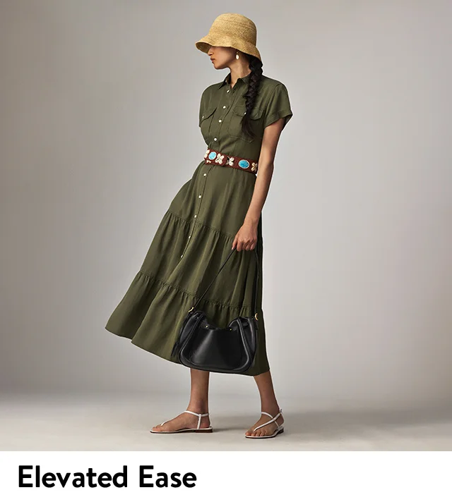 A woman wearing an olive-green shirt dress with a straw hat and sandals.