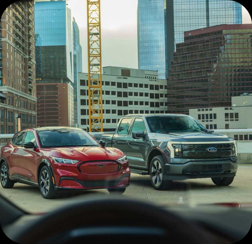 A Ford Mustang parked next to a F‑150.