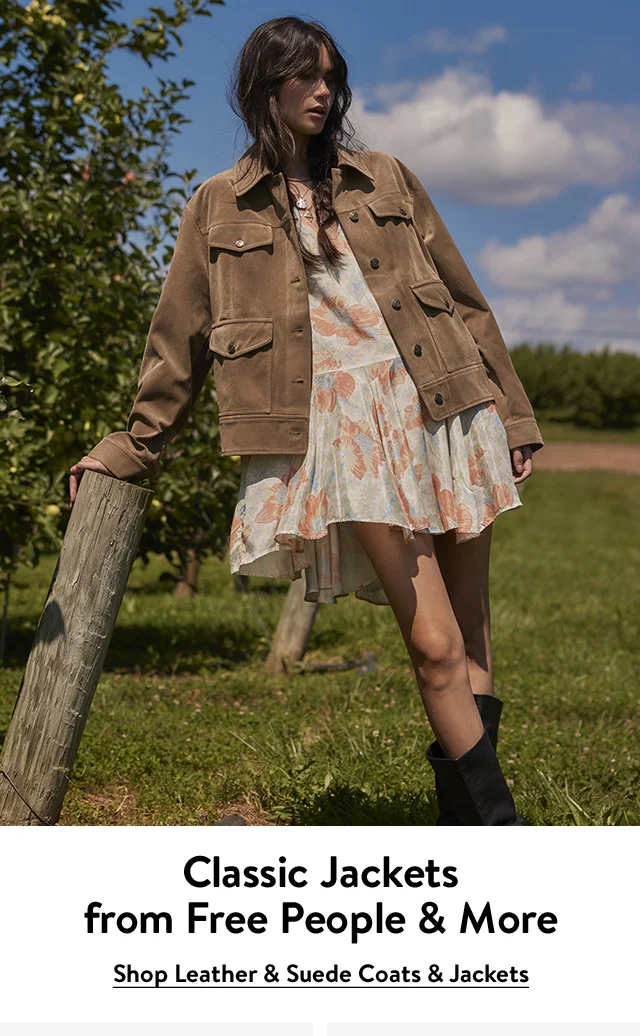 A woman wearing a brown suede jacket over a minidress.