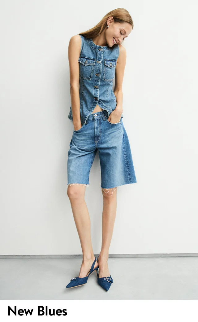 A woman wearing a denim top with knee-length denim shorts.