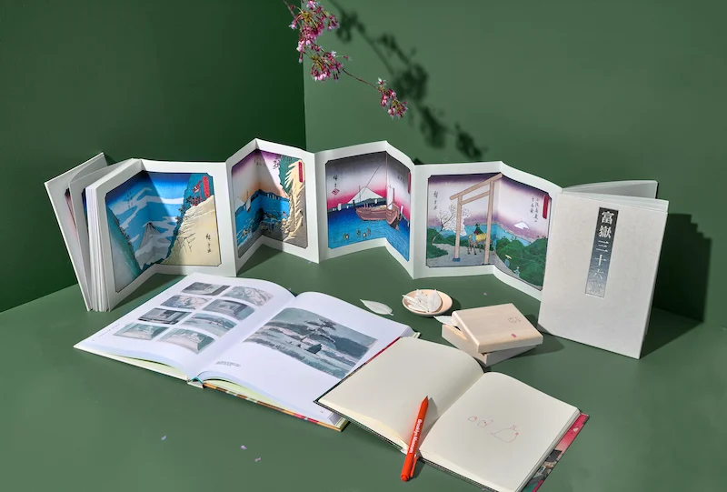 A photograph of notebooks and posters inspired by Hiroshige’s prints