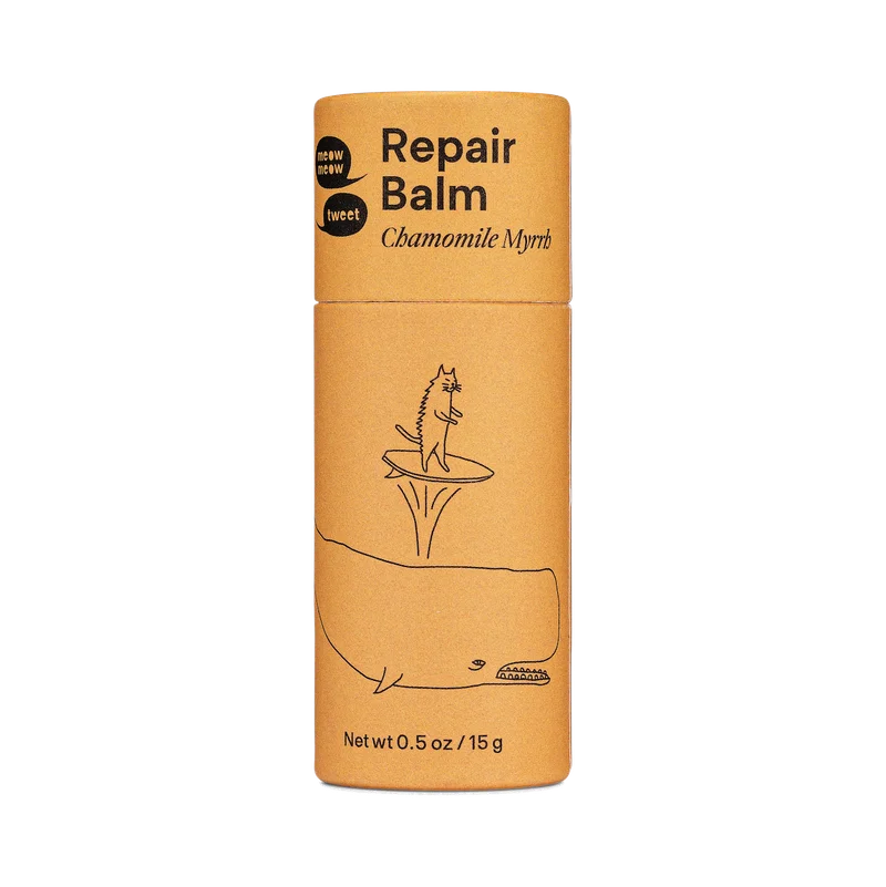 An orange paper tube of balm.