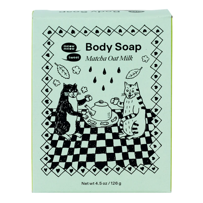 A green paper soap box with black line cat illustration.