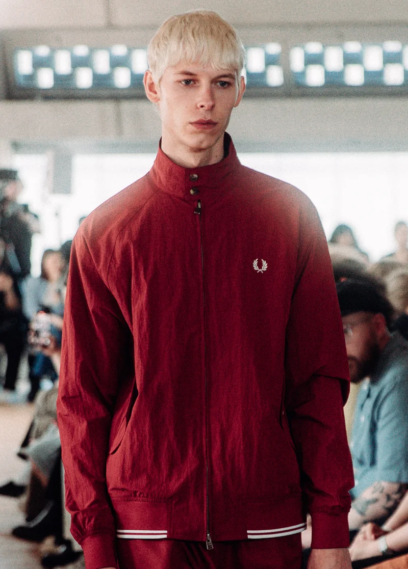 Male white model with bleached short hair walks the runway in our red Crinkle textured Harrington Jacket