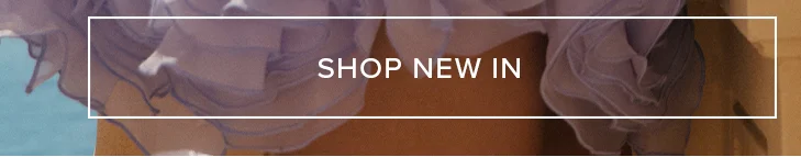 Flowing light lavender fabric from new apparel, layered over warm brown tones. A white text box reads, "SHOP NEW IN" for latest arrivals.