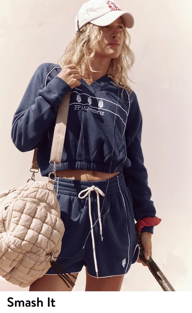 A woman wearing a matching pullover and shorts.