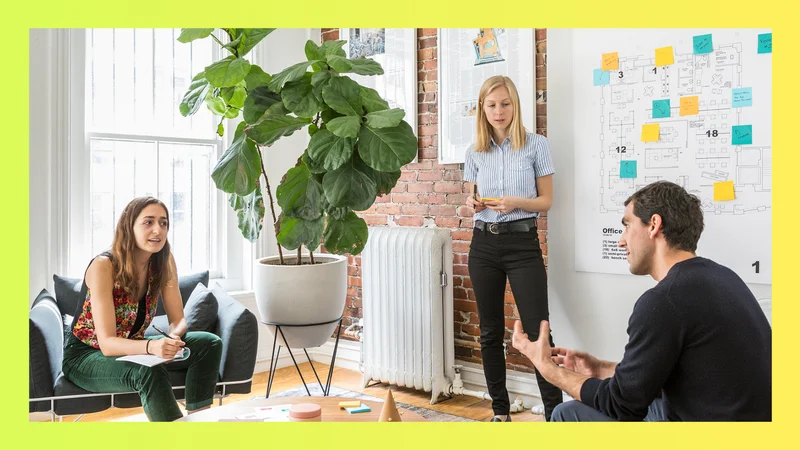 Three people meeting in a conference room