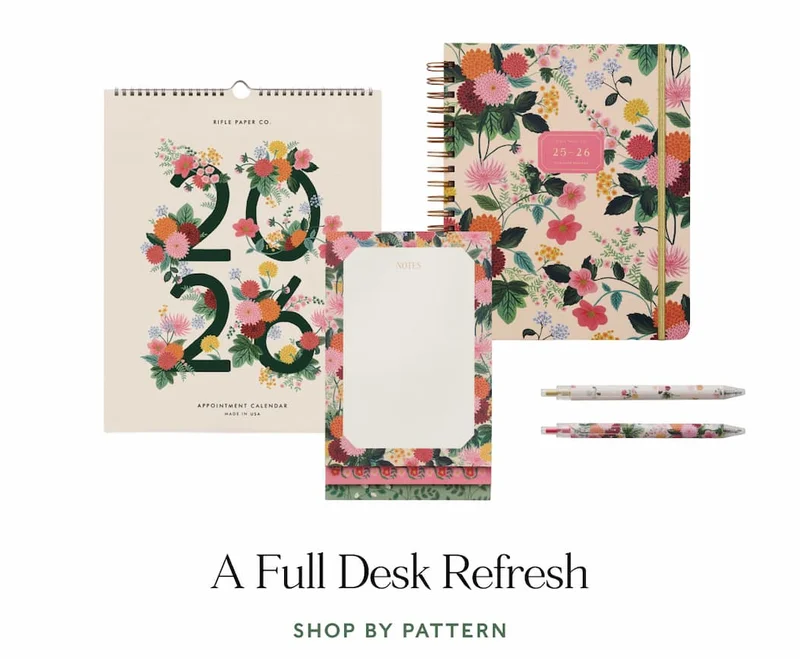 Floral 2026 calendar, planner, notepad, and pens displayed with the text "A Full Desk Refresh: and "Shop by Pattern."