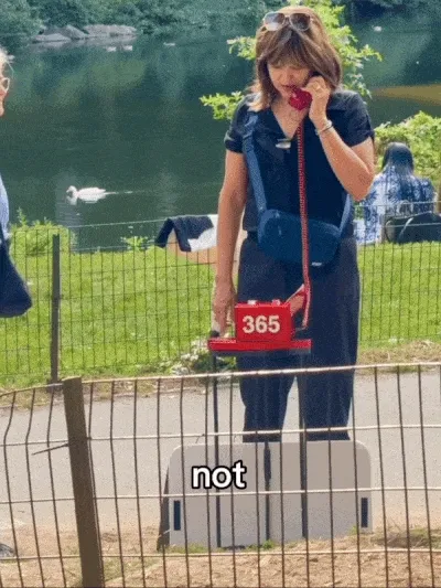 GIF of a woman talking on a red phone in a park the caption says, "not being the mother I could have and should have been to my son."