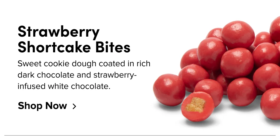 Strawberry Shortcake Bites; sweet cookie dough coated in rich dark chocolate and strawberry-infused white chocolate.Shop Now