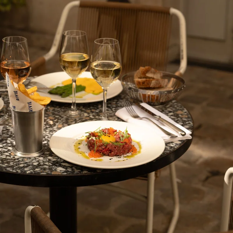 Outdoor table with wine, food