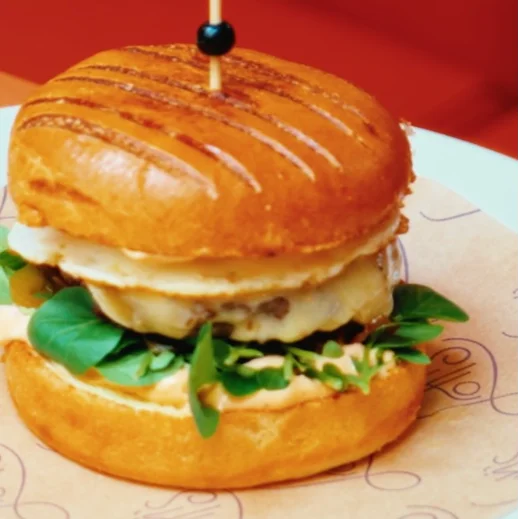 Cheeseburger with greens on bun