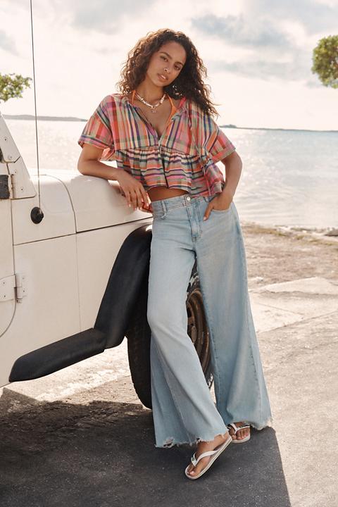 The Adi Regenerative Cotton Mid-Rise Frayed Relaxed Flare Jeans by Pilcro