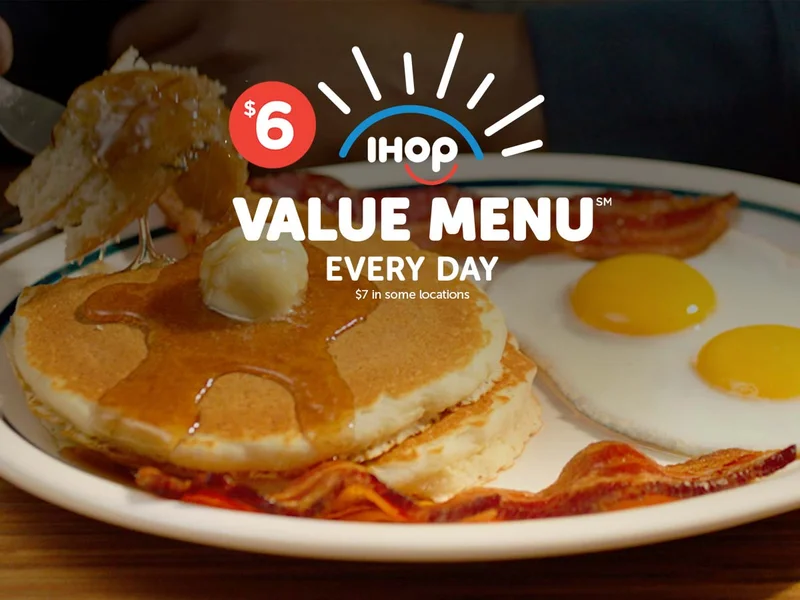 Stack of 2 pancakes, 2 eggs, and 2 strips of bacon.