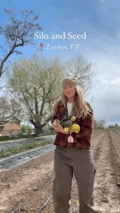 Short clips of a person with light skin and blonde hair on a flower farm holding up and applying skin cream. Also short clips of skin cream and colorful deodorant sticks lying next to flowers.