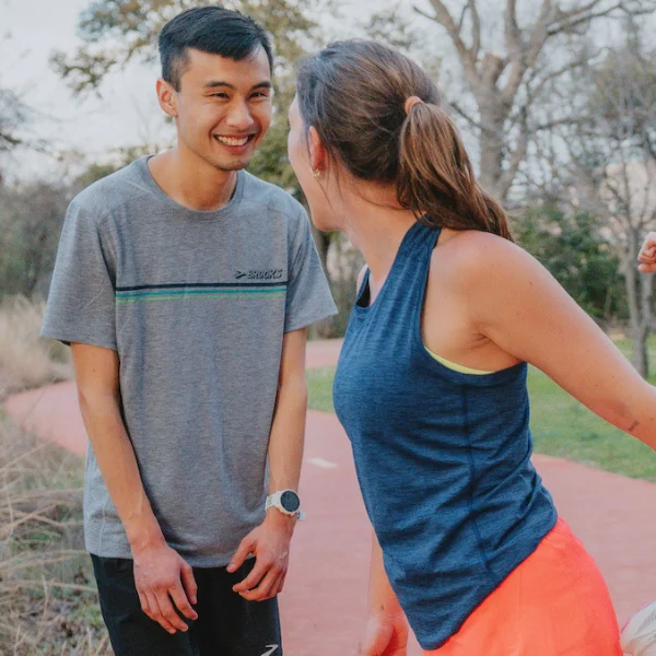 Man and woman wearing Brooks tops