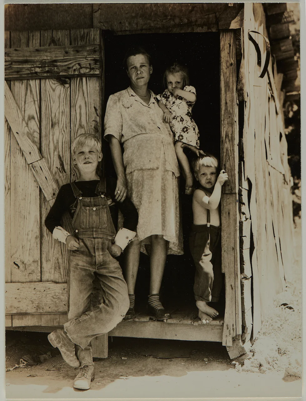 A woman and three children stand in a doorway