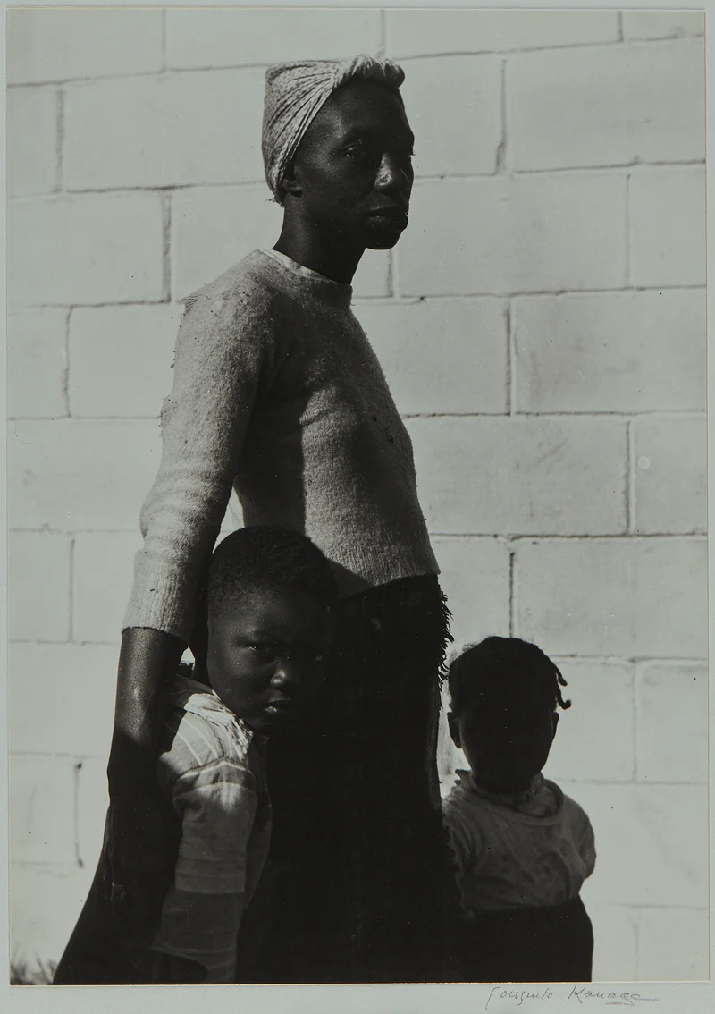 A woman and two young children
